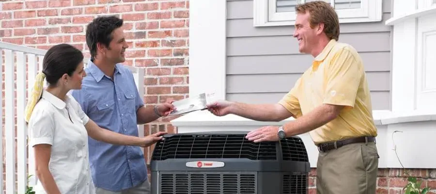 trane dealer handing brochure to homeowners